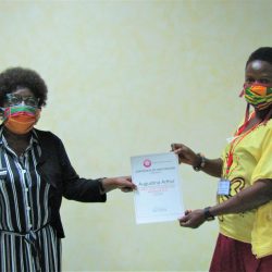 Madam-Dorcas-handing-over-a-certificate-to-a-participant-scaled
